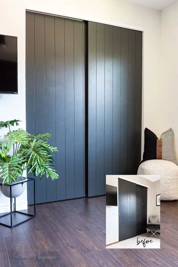 a living room with wooden floors and black sliding doors in front of a tv on the wall