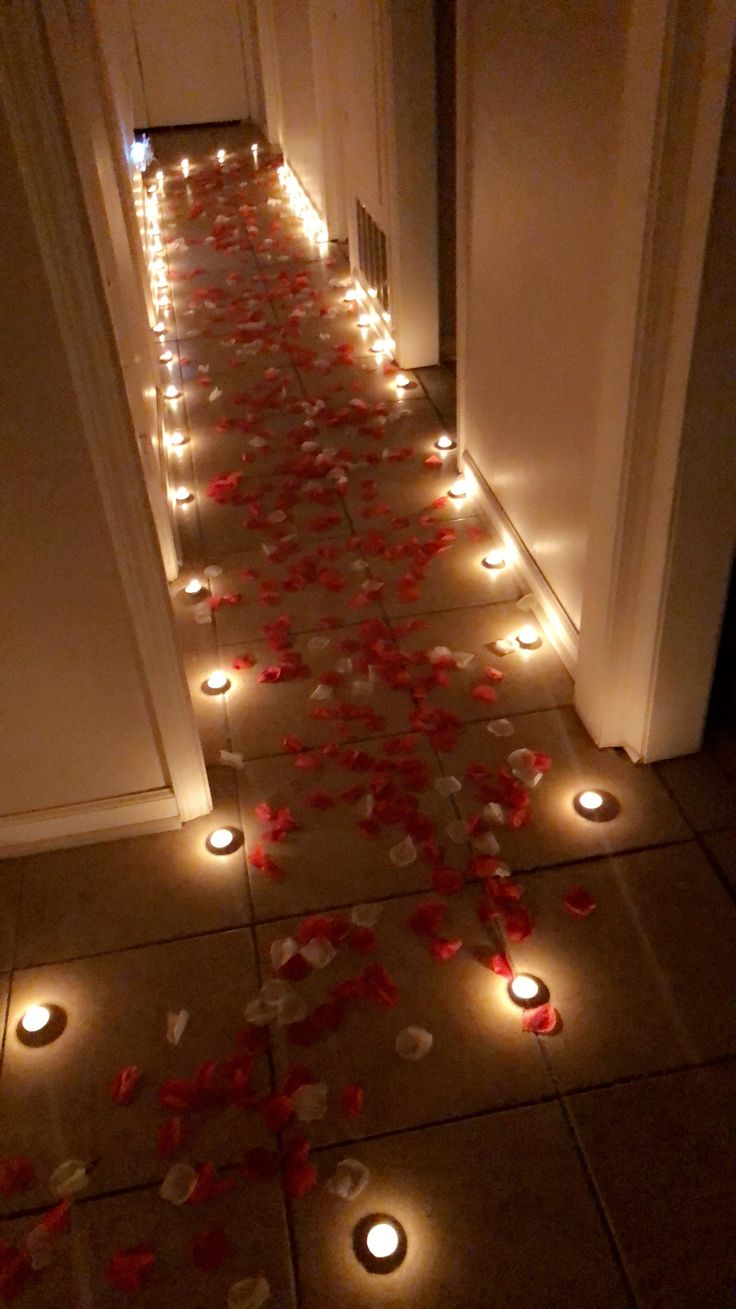 the hallway is decorated with candles and rose petals