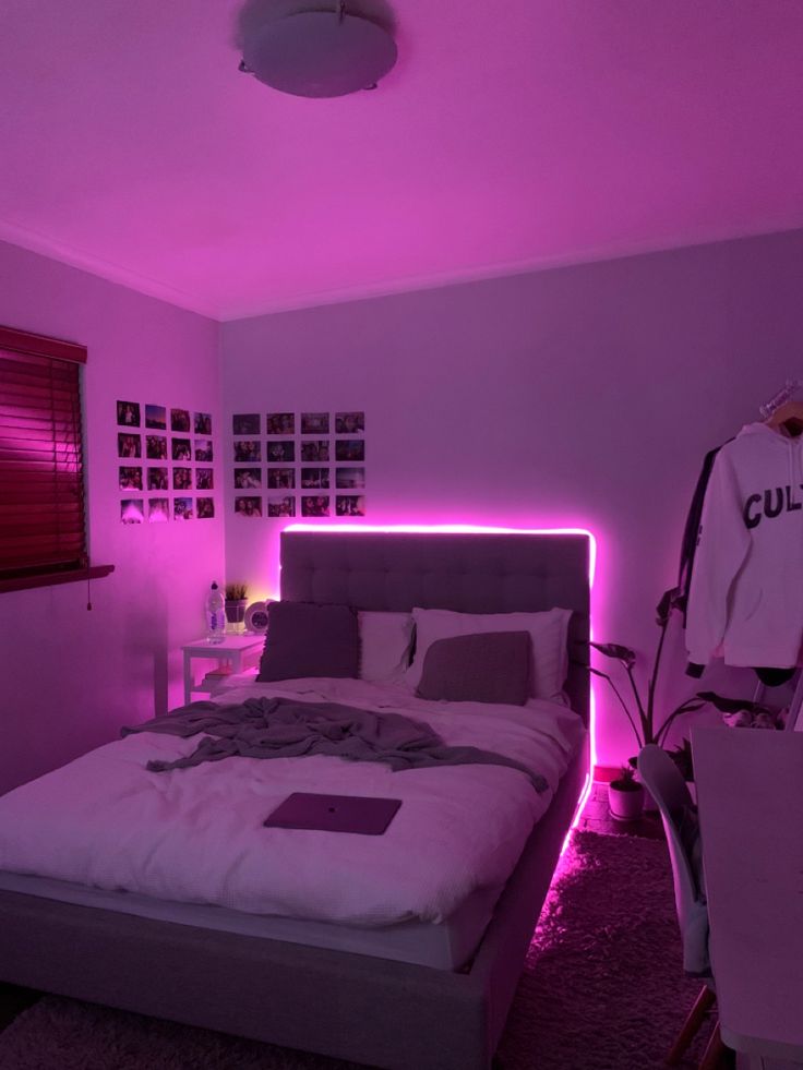 a bed in a room with purple lighting