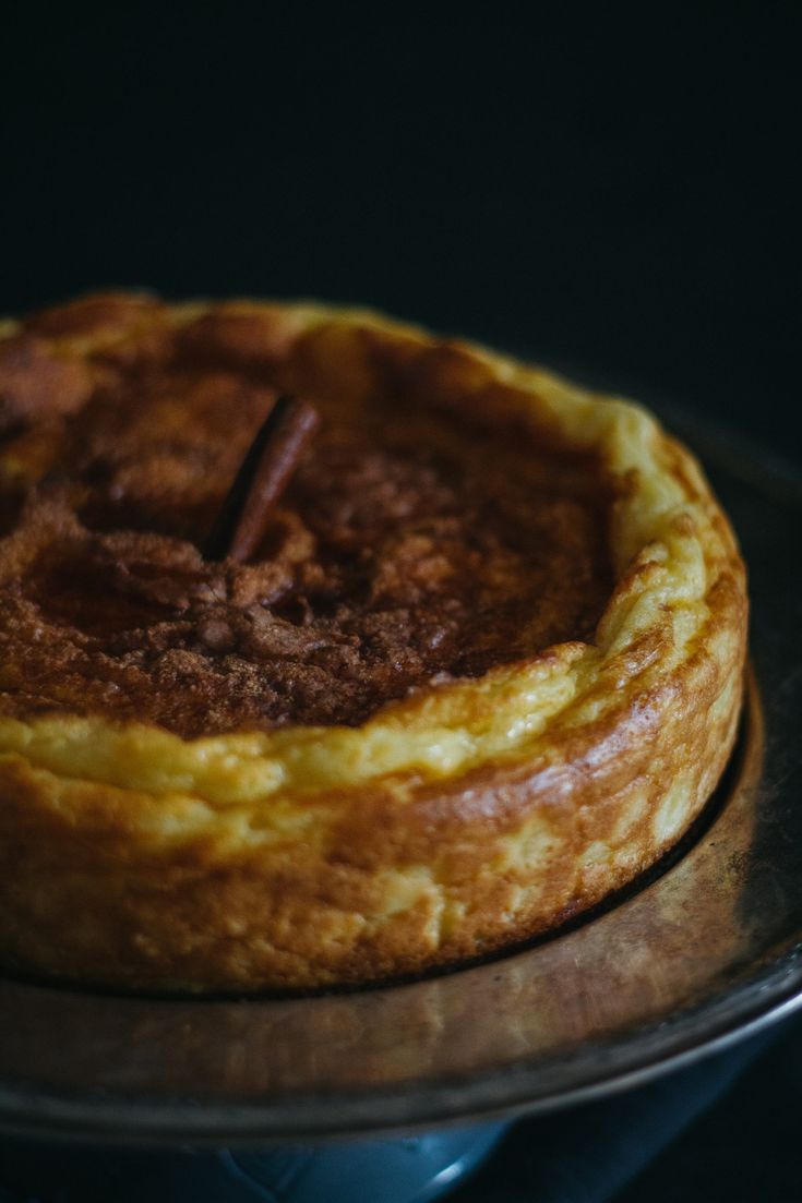 a baked pastry sitting on top of a metal pan with a wooden stick sticking out of it