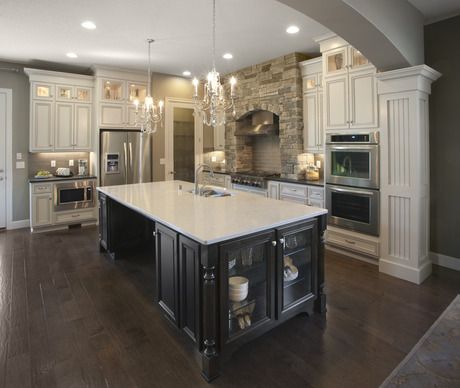 a large kitchen with an island in the middle and two ovens on each side