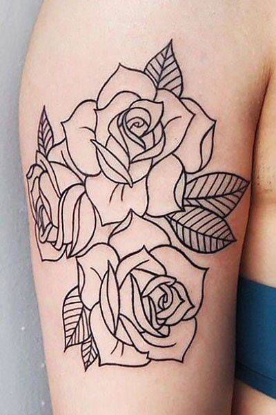 a black and white rose tattoo on the arm