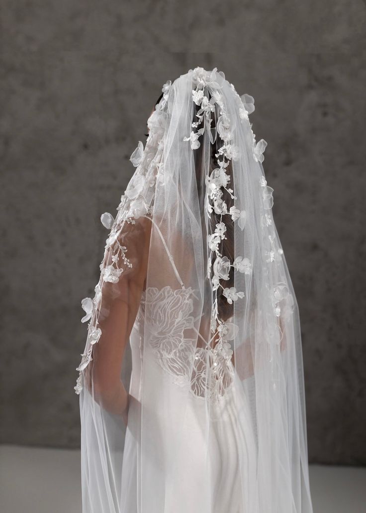 a woman wearing a veil with flowers on it