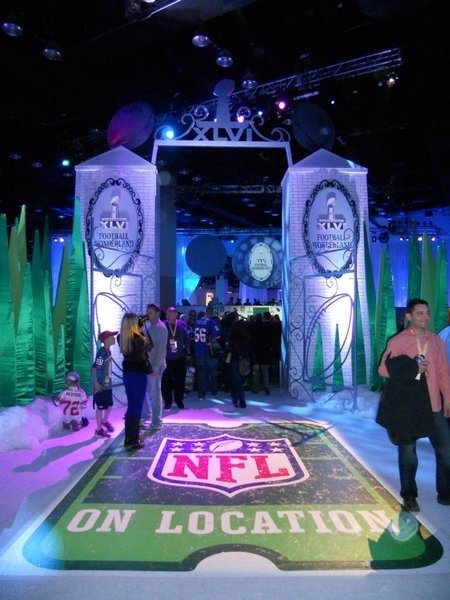 people are standing in front of an ice sculpture at the nfl on location showroom