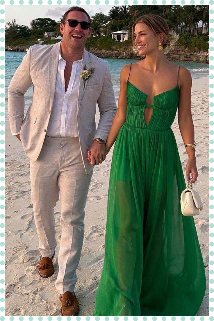 a man and woman in formal wear walking on the beach with their hand in each other's pockets