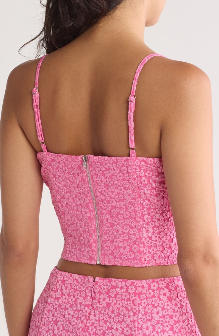 Flowery lace furthers the sweetness of this bustier-inspired crop top that's rendered in pretty pink. 15 1/2" length Exposed back-zip closure Sweetheart neck Adjustable straps 100% polyester Hand wash, line dry Imported Pink Crop Top With Built-in Bra, Spring Pink Spaghetti Strap Corset, Pink Spaghetti Strap Corset For Spring, Pink Spaghetti Straps Corset For Spring, Pink Sleeveless Corset For Spring, Pink Corset With Spaghetti Straps For Summer, Pink Fitted Corset With Spaghetti Straps, Pink Fitted Crop Top With Built-in Bra, Fitted Pink Cami Crop Top