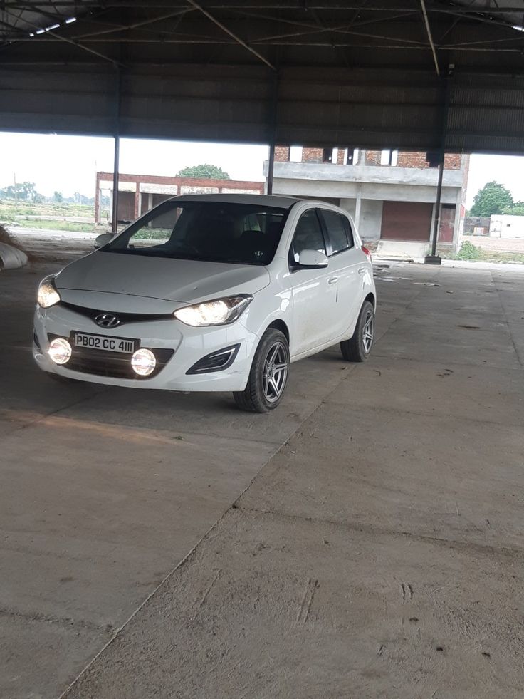 a white car parked in an empty parking garage