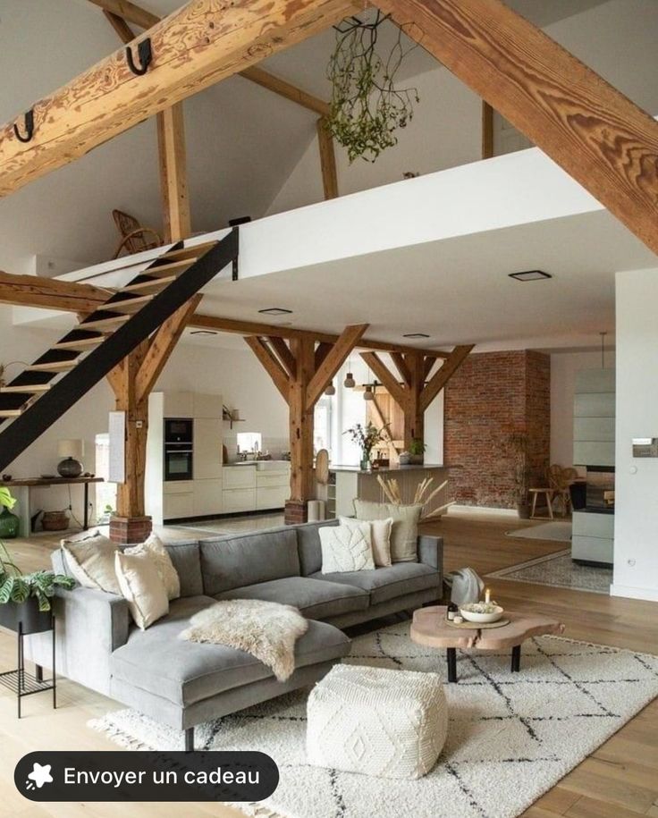 a living room filled with furniture and wooden beams