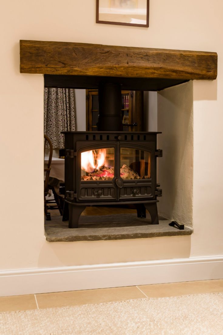 a wood burning stove sitting inside of a living room