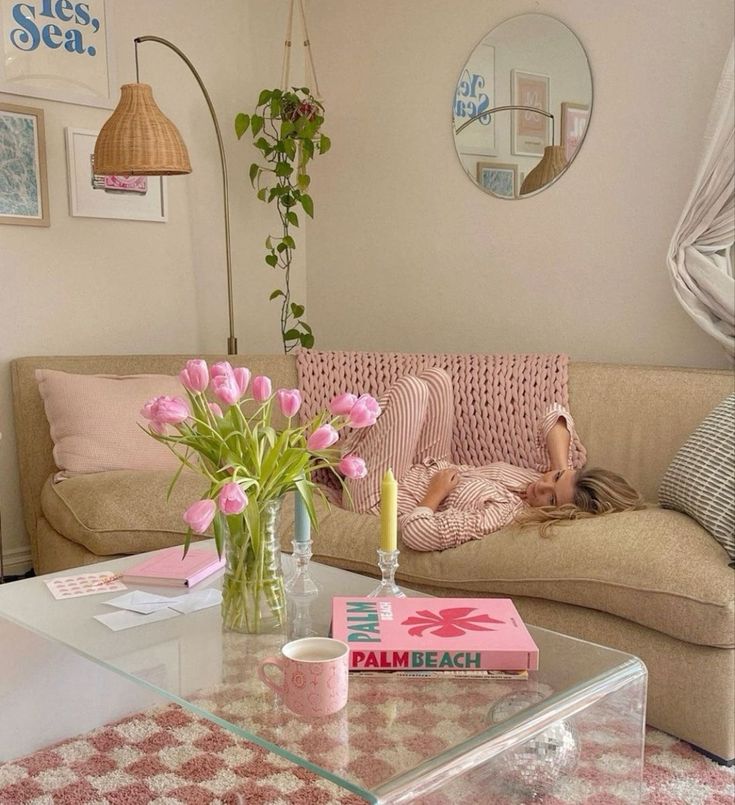 a living room filled with furniture and pink flowers