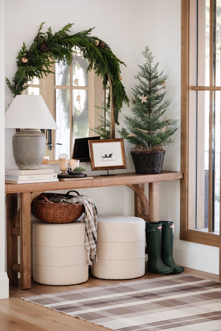 the entryway is decorated for christmas with wreaths and potted trees