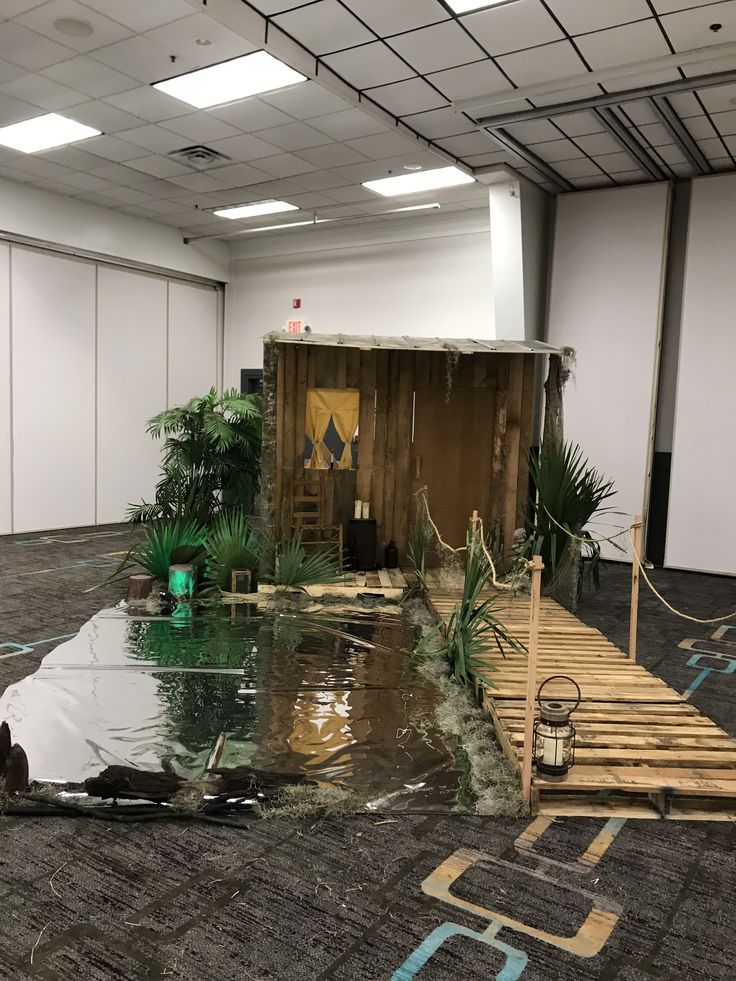 an empty room with water on the floor and plants growing out of the area in front of it