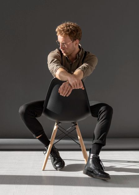 a man sitting on top of a black chair