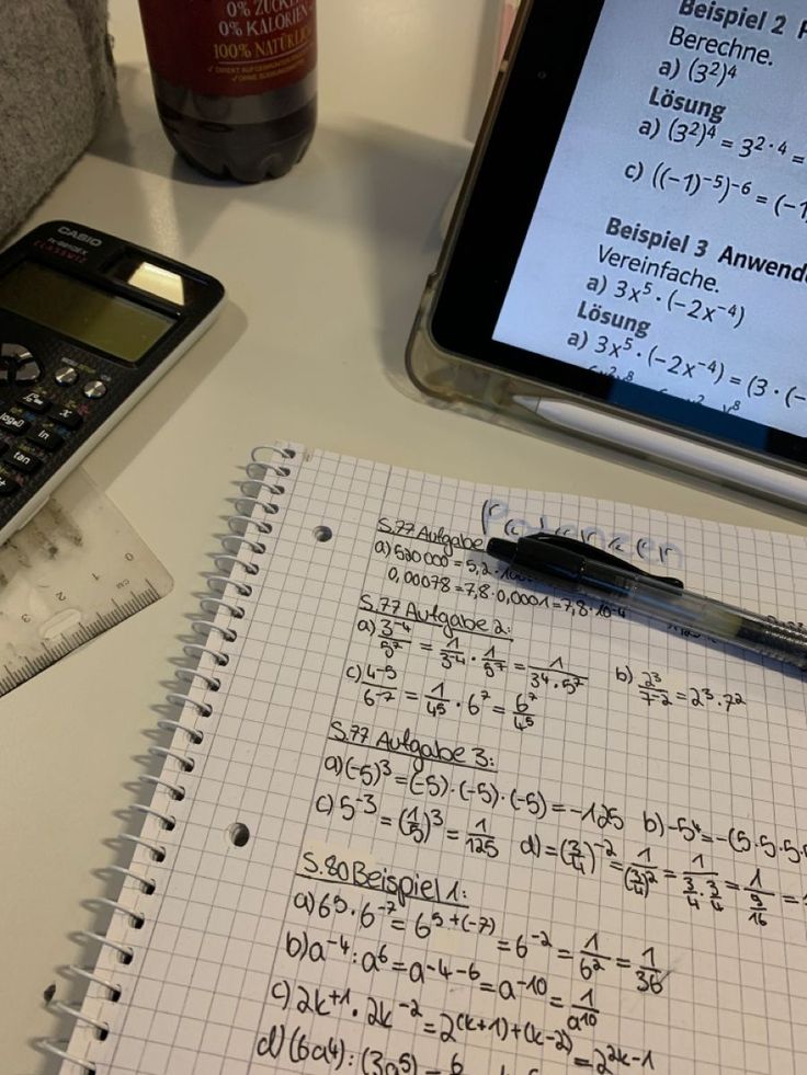 a calculator sitting on top of a table next to a notebook