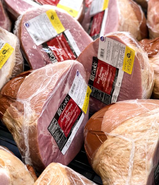 ham wrapped in plastic and ready to be sold at the grocery store for $ 3 99 per pound