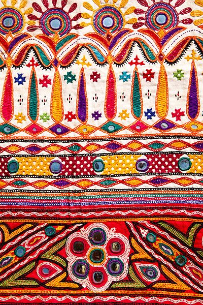 an intricately designed piece of cloth with colorful patterns and designs on the fabric is shown