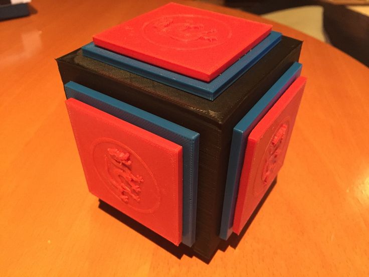 two red and blue blocks sitting on top of a wooden table