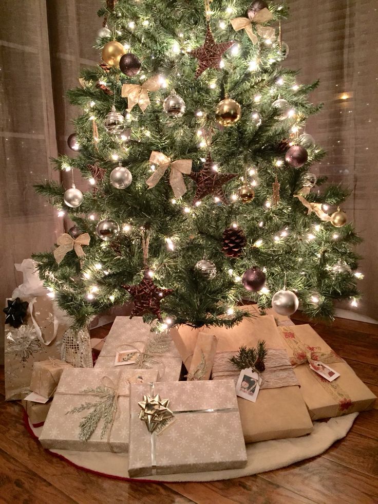 a christmas tree with presents under it