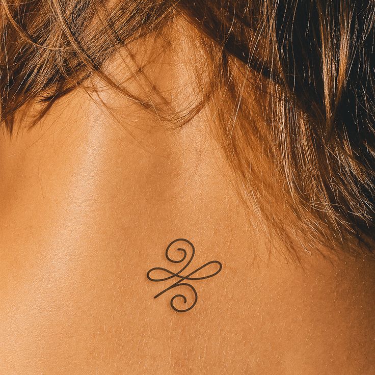 a woman with a tattoo on her back neck