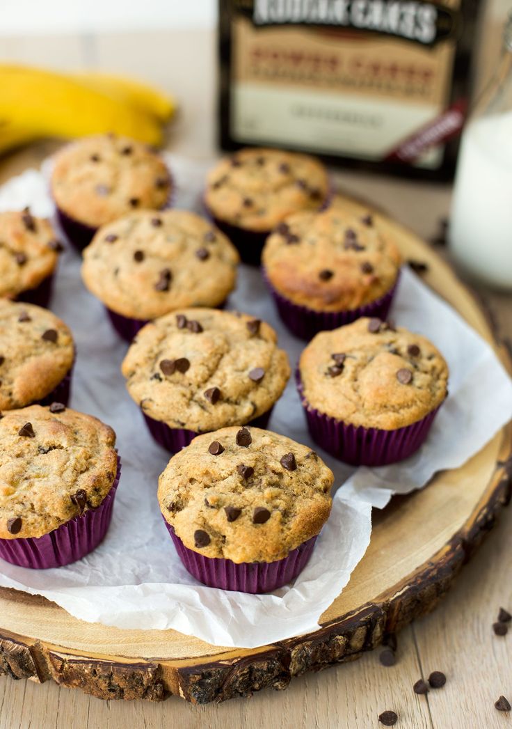 chocolate chip muffins sitting on top of a wooden plate