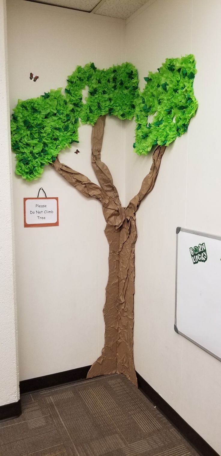 a paper mache tree in an office cubicle