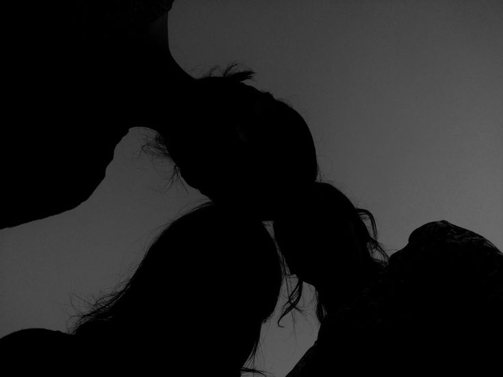 the silhouette of two people kissing each other