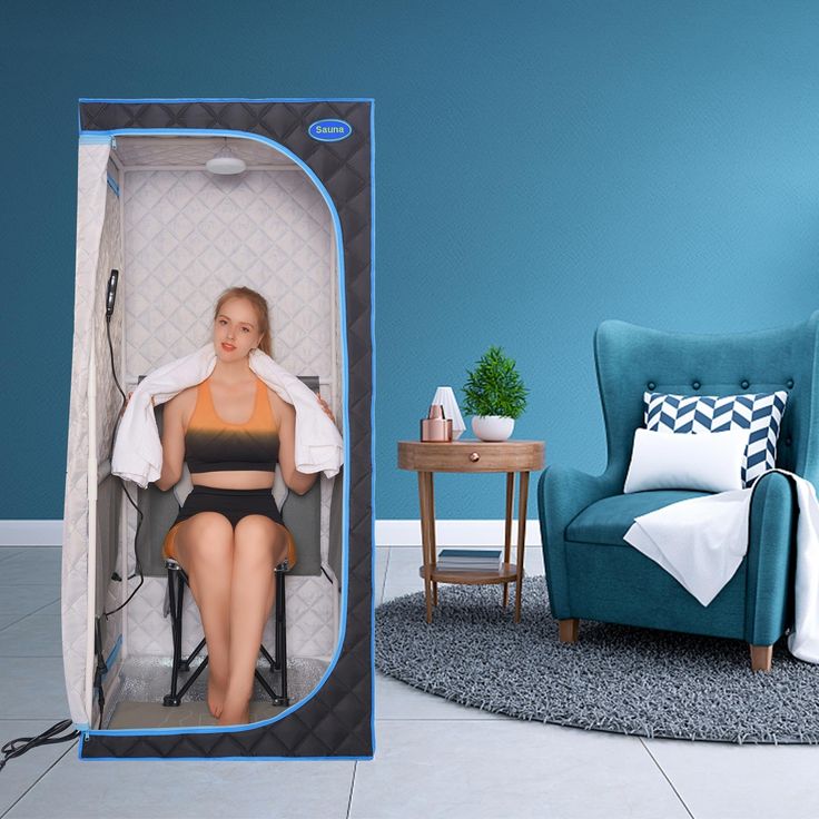 a woman is sitting in the shower with her legs crossed