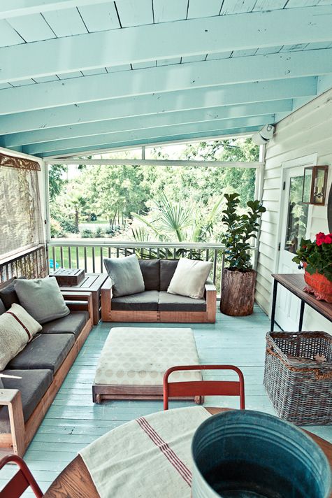 a porch with couches and chairs on it