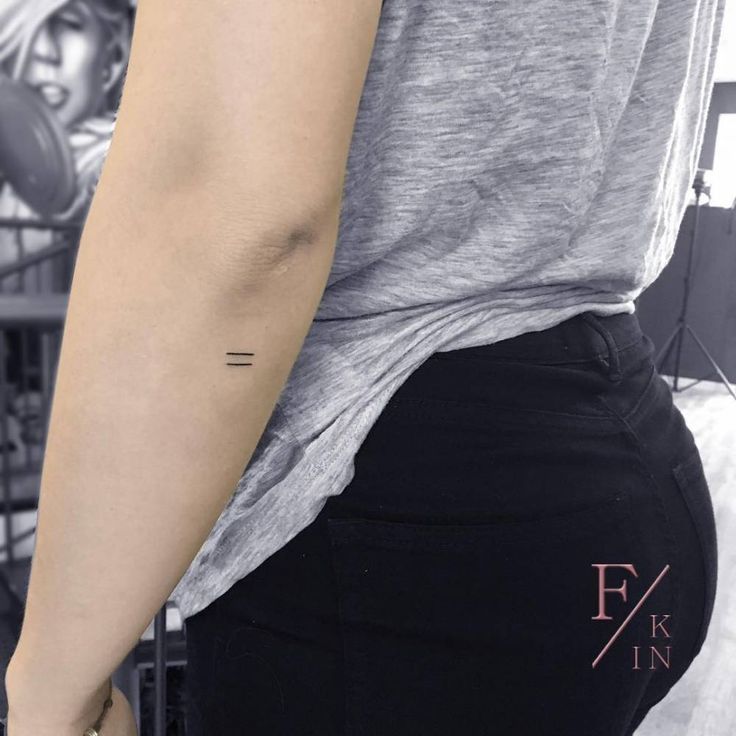 a woman's left arm with a small tattoo on the back of her right arm