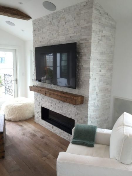 a large flat screen tv mounted to the side of a wall in a living room