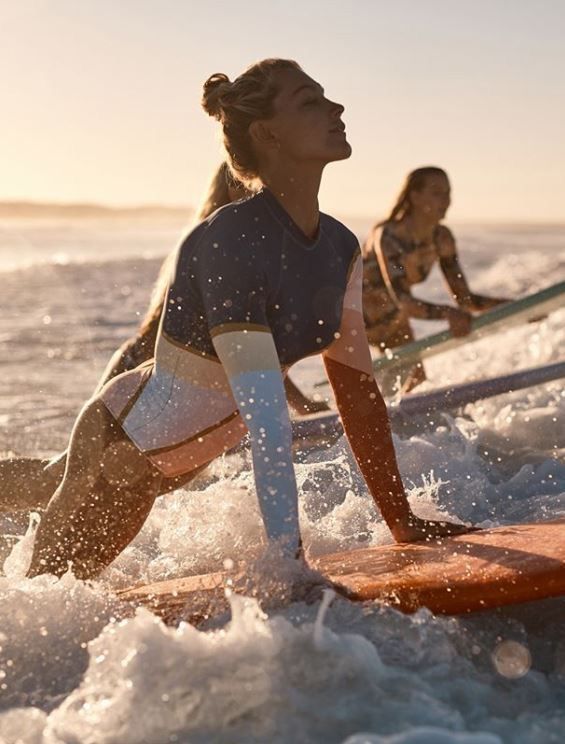 two women on surfboards in the water