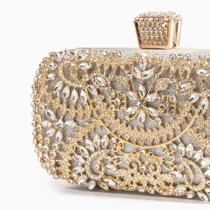 Be captivated by our Luxurious Flower Clutch Bag. This enchanting clutch boasts an intricate metal flower design adorned with sparkling premium rhinestones and a beautifully crafted clasp for a magnificent finish. Designed to accommodate your phone and various small essentials, this darling clutch is the perfect blend of style and practicality. Elevate your accessory game with this exquisite piece that adds a touch of glamour to any outfit. Shoulder strap included. Crafted from vegan & cruelty-f Flower Clutch, Prom Bag, Rhinestone Handbags, Floral Clutches, Floral Heels, Gold Clutch, Beautiful Handbags, Bridal Belt, Metal Flower