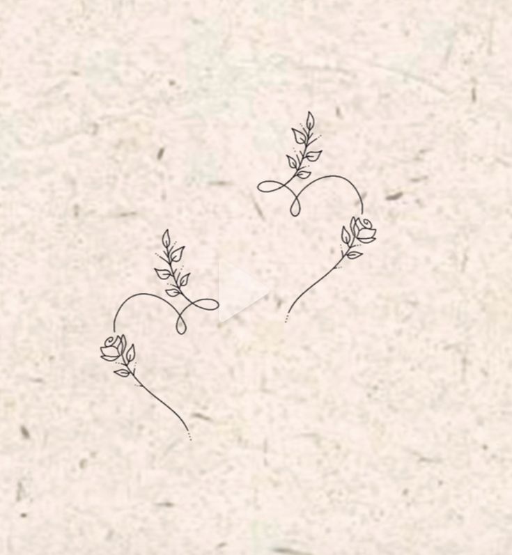 two small flowers are drawn on a piece of paper with the word love written in it