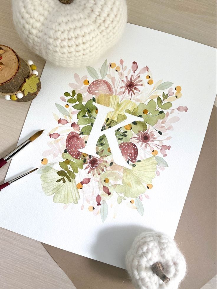 a white paper with a flower design on it next to crochet yarn and scissors