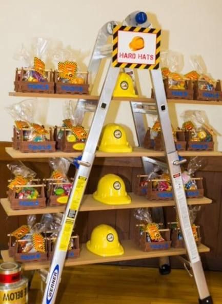 a ladder that has some kind of yellow hat on it with other items in the background