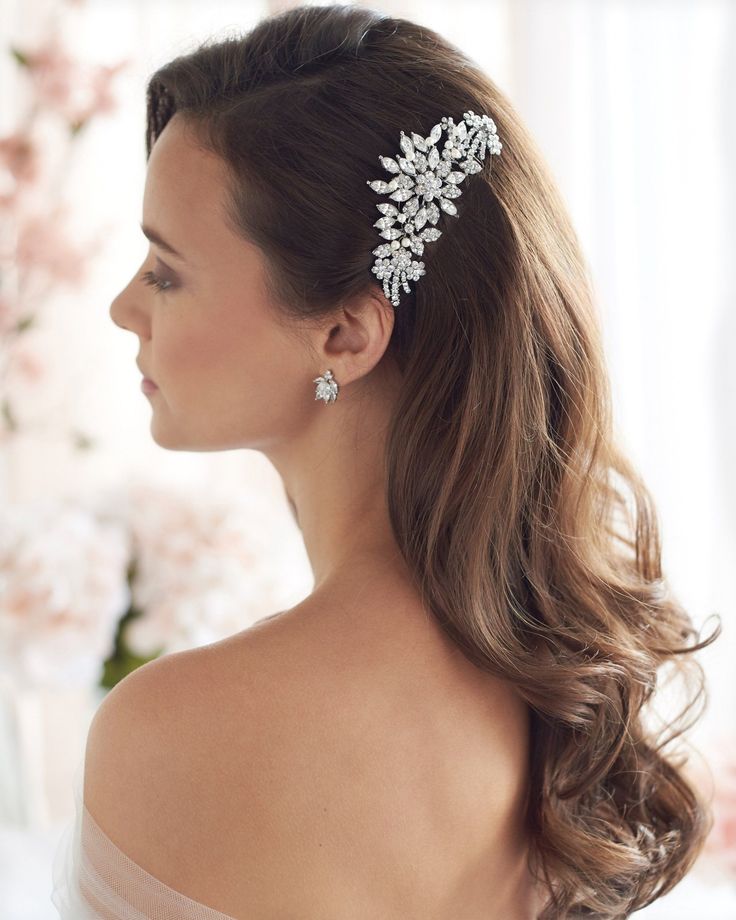 a woman wearing a hair comb with flowers on it's head and long hair in the back