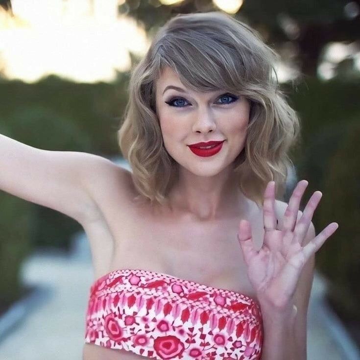 a woman in a red and white top with her hands out to the side,