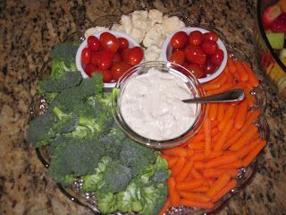 a platter filled with vegetables and dip