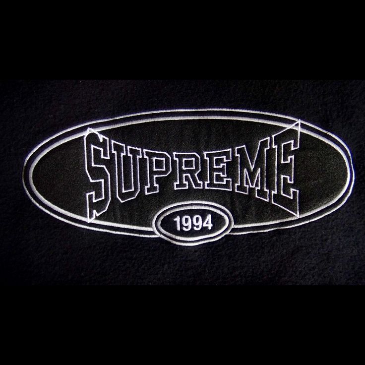 the supreme logo is shown in white and black on a black background with an oval outline