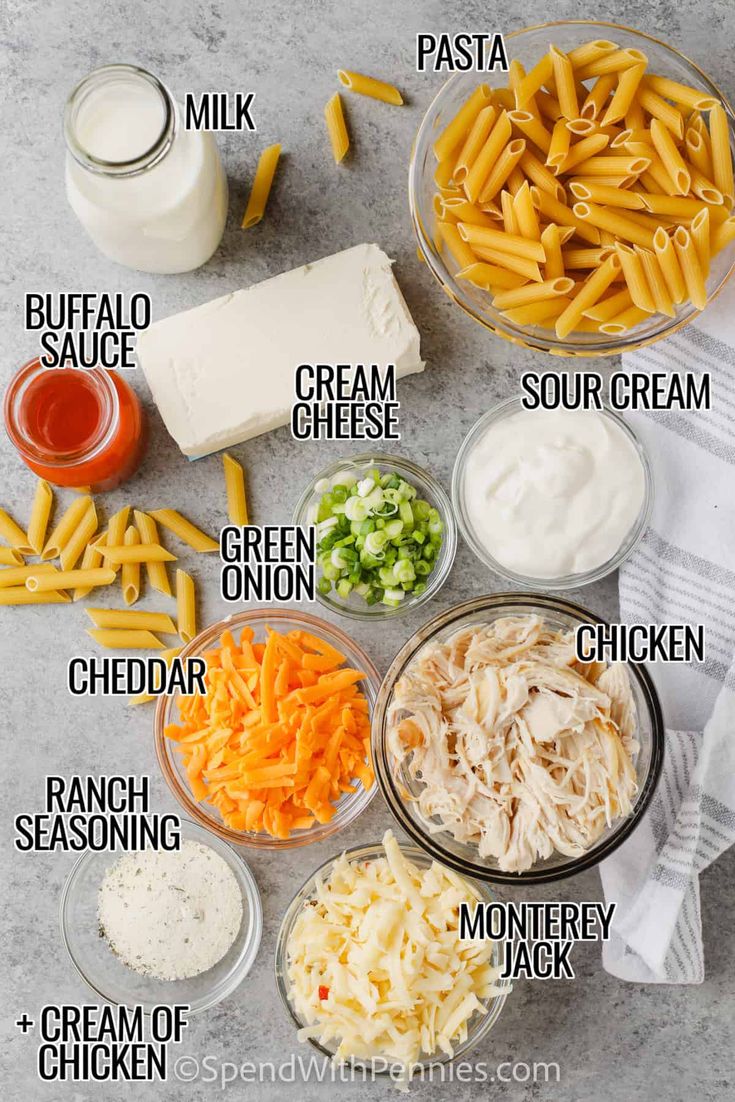 the ingredients to make pasta salad laid out in bowls on a gray surface with text overlay