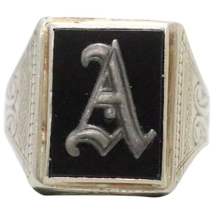 "Stunning vintage white gold ring with the initial \"A\" design on black onyx. The initial \"A\" has an Old English style of writing. The black onyx stone is secured with a fine bezel set. This ring is a size 9 1/2 and weighs a total of 7.8 g. This ring is hallmarked 14K and was inspected by a professional for authenticity." Vintage Black Engraved Round Ring, Classic Black Sterling Silver Engraved Ring, Luxury Black Engraved Ring For Anniversary, Elegant Signet Ring As Collectible, Black Engraved Ring With Polished Finish For Formal Occasions, Black Symbolic Anniversary Jewelry, Black Symbolic Jewelry For Anniversary, Symbolic Black Jewelry For Anniversary, Vintage White Gold Initial Ring For Formal Occasions