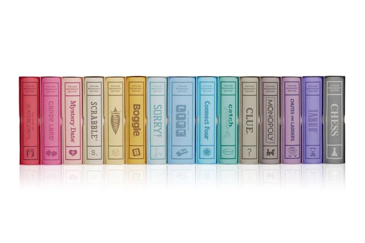 a row of colorful books sitting next to each other on top of a white surface