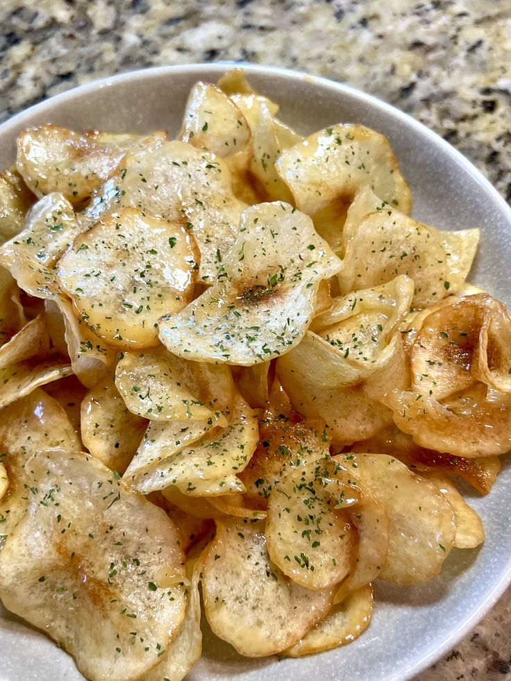 a white plate topped with potato chips covered in seasoning