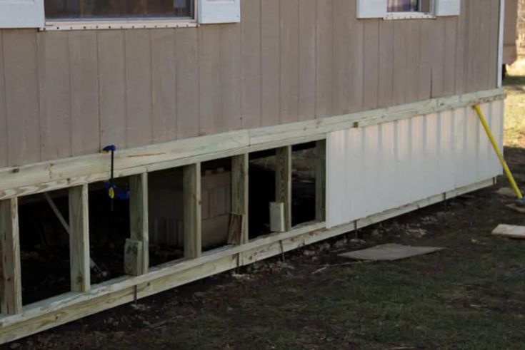 the side of a house that is being built with siding and windows on each side