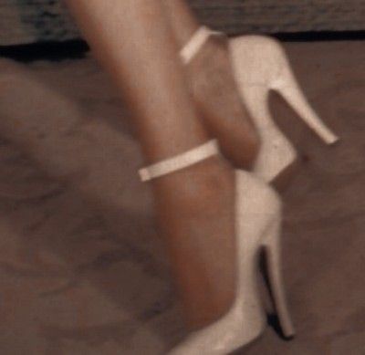 a woman's legs wearing white high heels