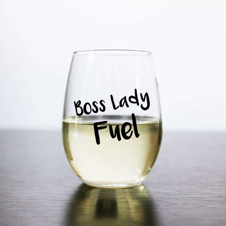 a glass filled with liquid that says boss lady fuel on the bottom and black writing