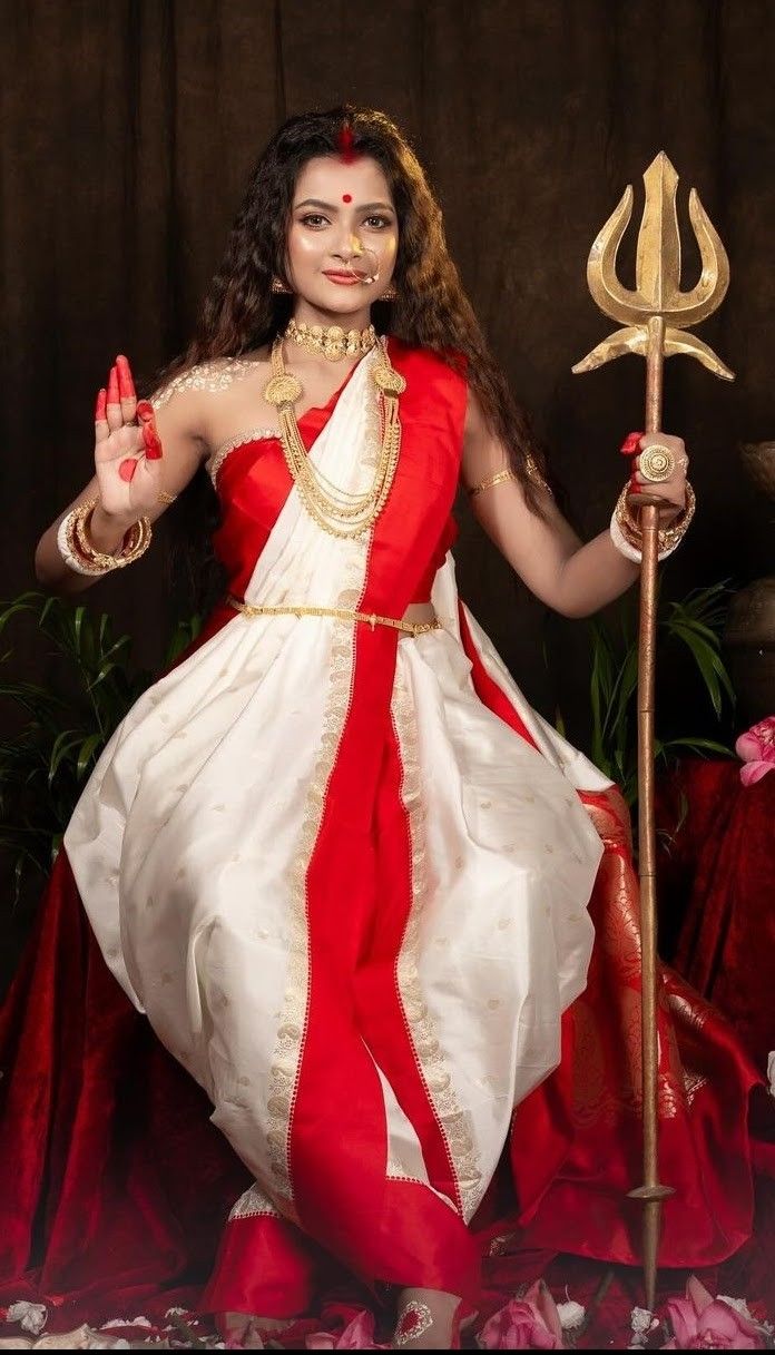 a woman dressed in red and white holding a staff