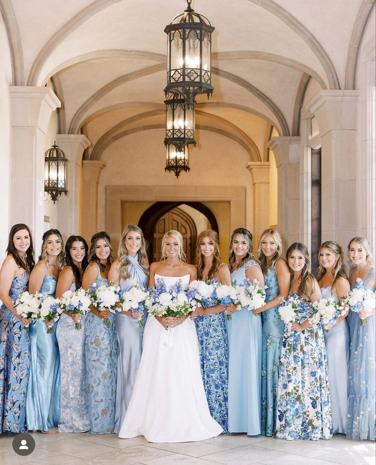 a group of women standing next to each other in front of a chandelier