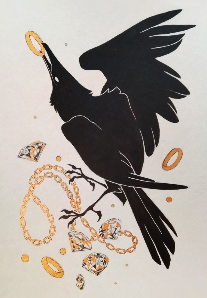 a black bird sitting on top of a piece of paper next to chains and rings