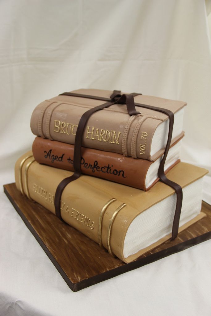 three books stacked on top of each other with a ribbon tied around the book ends